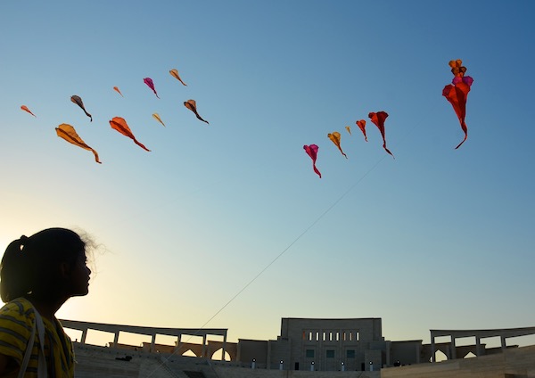 Flowx installation with girl interacting with the kite.  WindFire Designs outdoor event
