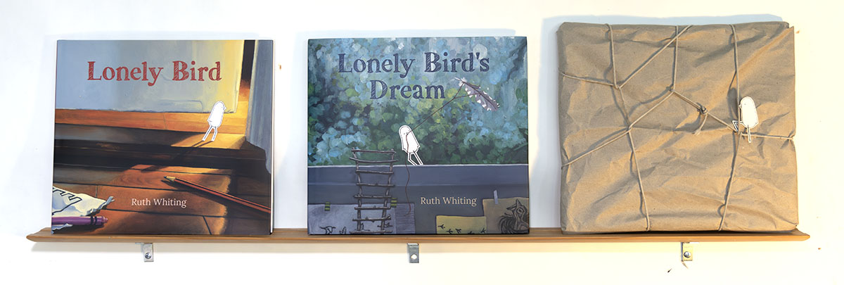 Three lonely bird books on a shelf with the third one still wrapped up and mysterious - The Lonely Bird series of books by Ruth Whiting