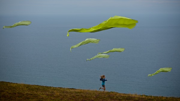 Girl running through a group of Flowx