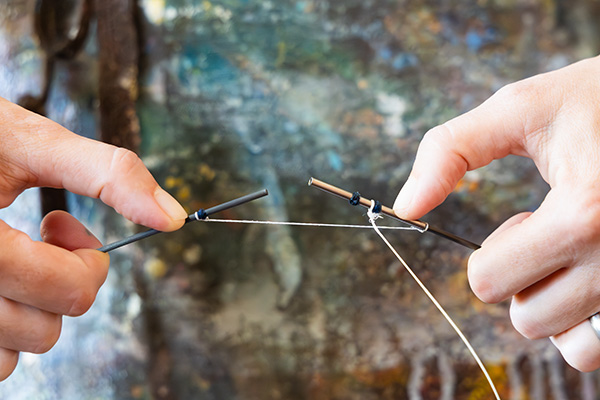 Ruth Whiting holds a painted Photon kite showing how the ferrules work on the carbon rods in her studio. Kite design by Tim Elverston