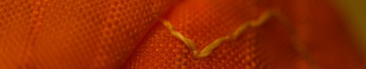 paraglider repair shot showing stitching of patch going into the junction of a cell instead of jumping over the cell